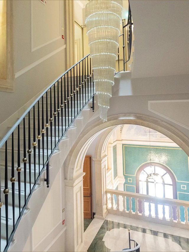 Lampadario a cascata in vetro di Murano sullo scalone del Grand Hotel Les Etrangères a Siracusa